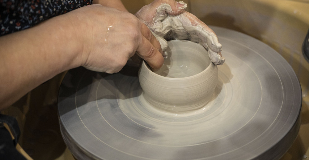 Olga Royo da forma a una pieza sobre el torno en su taller de cerámica.